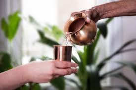 Pouring water into copper glass